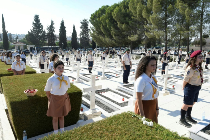 Cypriot scouts take part in a Republic of Cyprus ceremony in memory of soldiers killed 50 years earlier in the 1974 Turkish invasion of the island