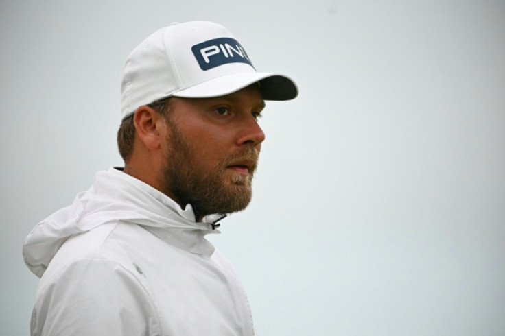 Daniel Brown handled the wet and windy conditions to lead at Troon