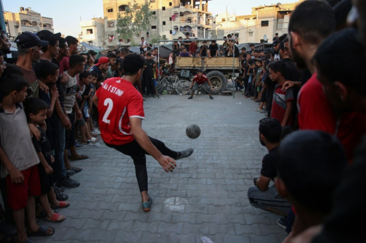 Displaced Palestinians play football in the courtyard of a UN-run school in Jabalia, northern Gaza -- the war has uprooted almost the entire population of the Gaza Strip, the UN says