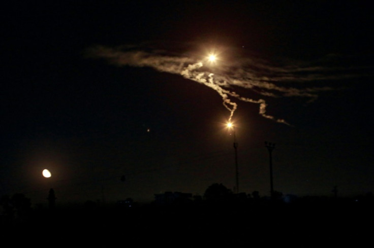Flares dropped by Israeli forces light up the sky over Khan Yunis