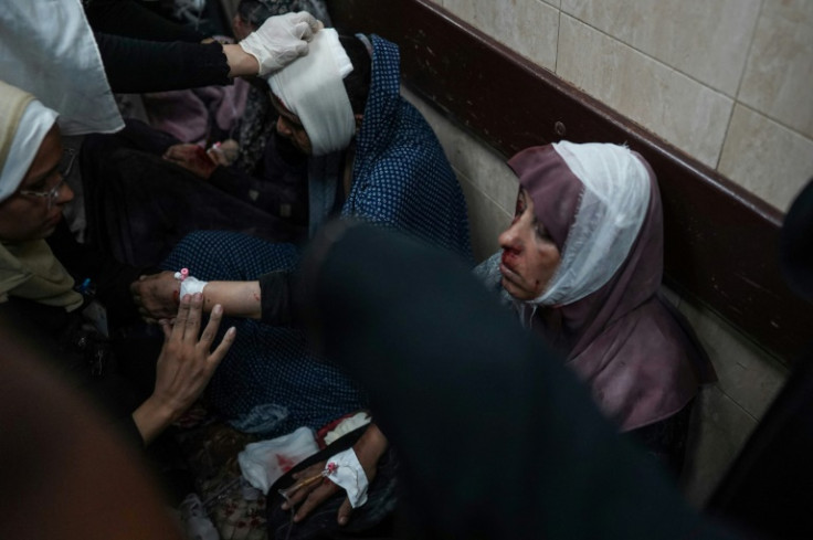 Injured women receive treatment at Al-Aqsa Hospital after an Israeli strike hit a school where they had taken refuge in Deir el-Balah, central Gaza