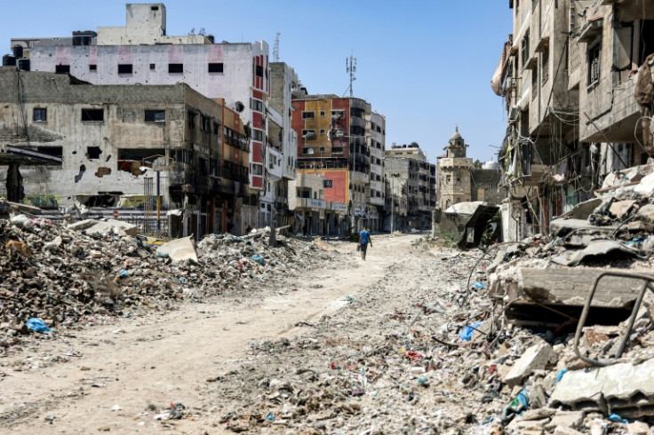 A man walks past rubble along a street in the Tuffah district in the east of Gaza City on July 8, 2024