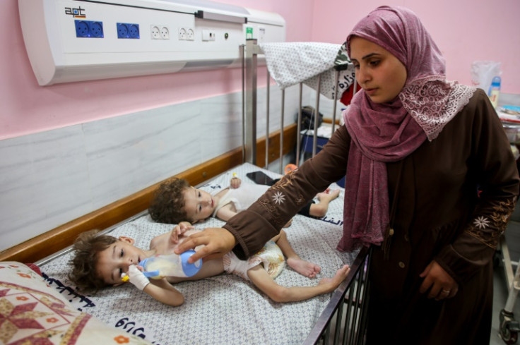 A Palestinian mother with her children, who are suffering from malnutrition, at the Kamal Adwan hospital in Beit Lahia in the northern Gaza Strip on July 9, 2024