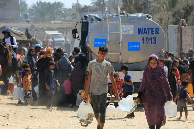Palestinians collect water from a UNICEF tanker in Deir el-Balah in the central Gaza Strip on July 9, 2024