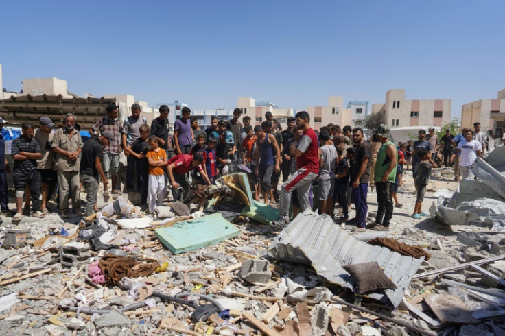 Palestinians inspect the rubble of a home in the southern Gaza city of Khan Yunis hit by Israeli bombardment