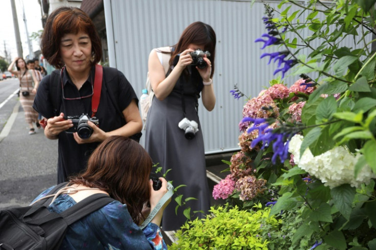 Participants of a film photography tour take photos in Kamakura, Kanagawa prefecture