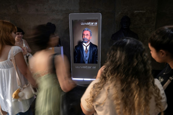 People interact with a AI-generated version of the Brazilian writer Machado de Assis during a guided tour at the Brazilian Academy of Letters in Rio de Janeiro, Brazil, on July 3, 2024