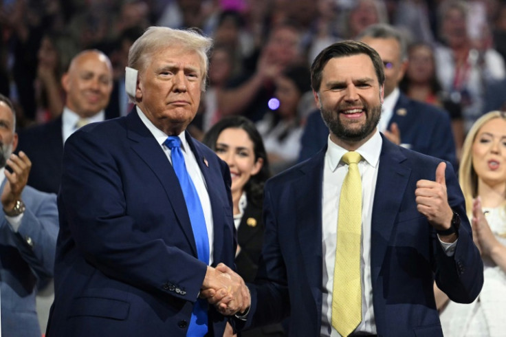 Republican vice presidential candidate J.D. Vance shakes hands with US former president and 2024 Republican presidential candidate Donald Trump