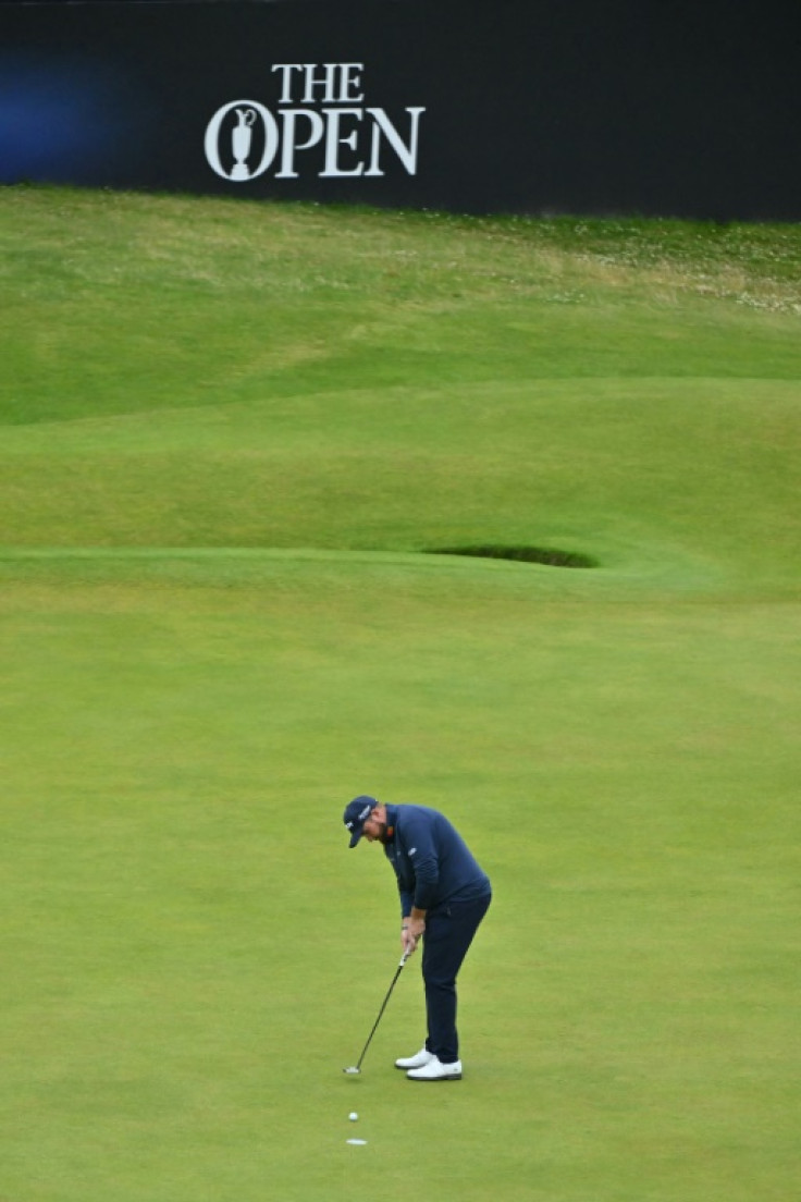 Shane Lowry makes a birdie putt on the 18th green to finish the opening day  at Troon one shot off the lead