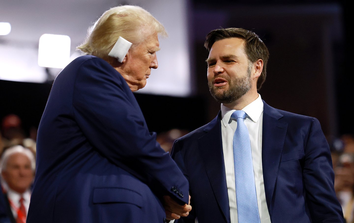 Trump leans toward J.D. Vance to shake his hand, onstage at the RNC.