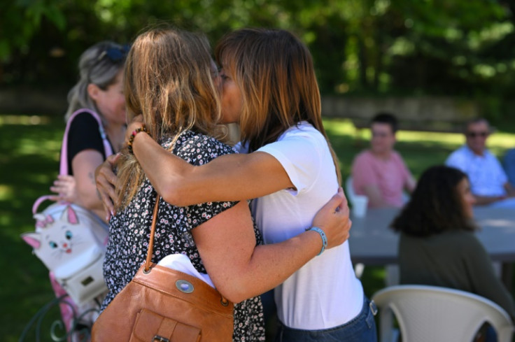 Two mothers who have lost children embrace at a support group in southern France