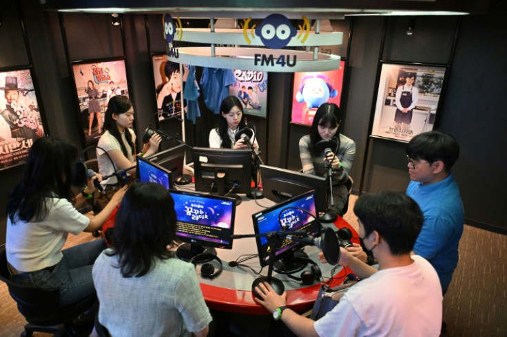Visitors practice their radio DJ skills in a mock studio at KidZania