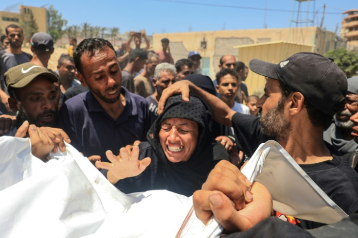 A woman reacts over the corpse of a family member after what the health ministry in Hamas-run Gaza called an Israeli strike on the Al-Mawasi area for displaced Palestinians
