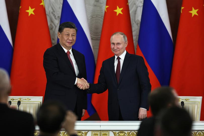 Russian President Vladimir Putin, right, and Chinese President Xi Jinping shake hands after speaking to the media during a signing ceremony following their talks at The Grand Kremlin Palace, in Moscow, Russia, Tuesday, March 21, 2023. (Mikhail Tereshchenko, Sputnik, Kremlin Pool Photo via AP)