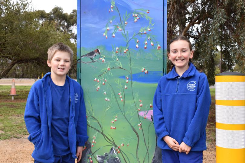 Cranbrook Primary School students Charlie Dixon, 7, and Isabelle Tomlinson, 8, with the new mural they helped create. 