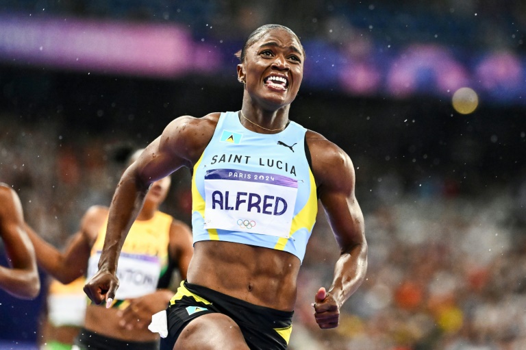 Saint Lucia's Julien Alfred celebrates after winning the women's 100m at the Paris Olympics