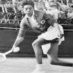 American tennis star Althea Gibson hits a return shot to Colette Monnot during her singles match at the Surrey Grass Court Championship, held at the Surbiton Racket and Fitness Club.