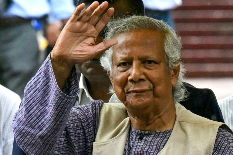 Nobel laureate and chief adviser of Bangladesh's new interim government, Muhammad Yunus greets the public after laying a wreath at the National Martyrs' Memorial in Dhaka on August 9