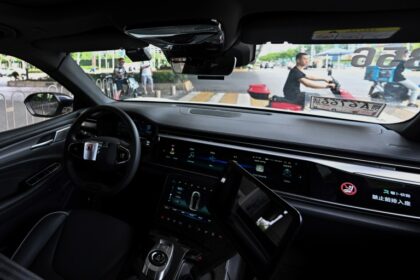 A view from the back seat of a driverless taxi as it navigates through Wuhan, now home to more than 500 so called "robotaxis"