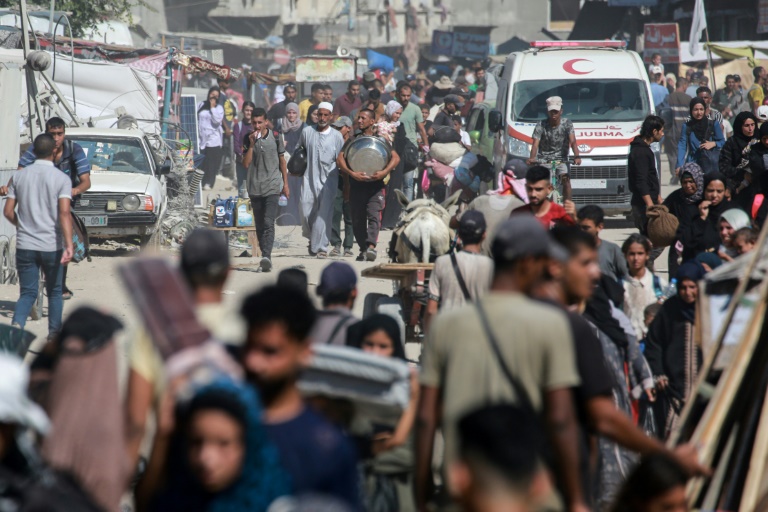 Displaced Palestinians leave an area of Khan Yunis city in Gaza after a new Israeli evacuation order