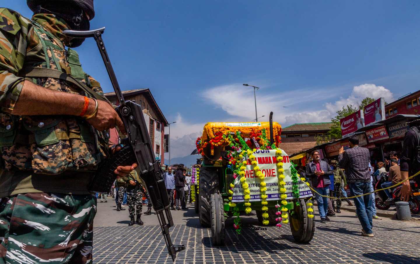 Indian policemen stand guard as Kashmiri Pandits participate in a procession to mark the Ramnavmi festival on April 17, 2024, in Srinagar, Kashmir.