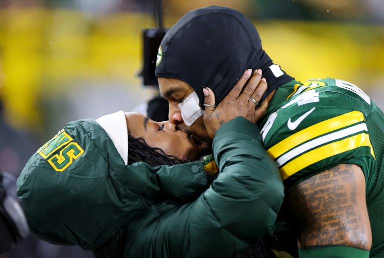 Simone Biles kisses husband Jonathan Owens before an NFL game between the Green Bay Packers and Kansas City Chiefs