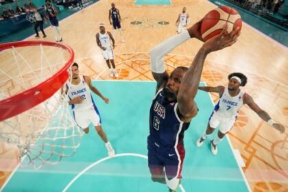 LeBron James dunks as the USA take on France for the men's basketball gold