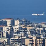 A commercial airplane flies over Beirut