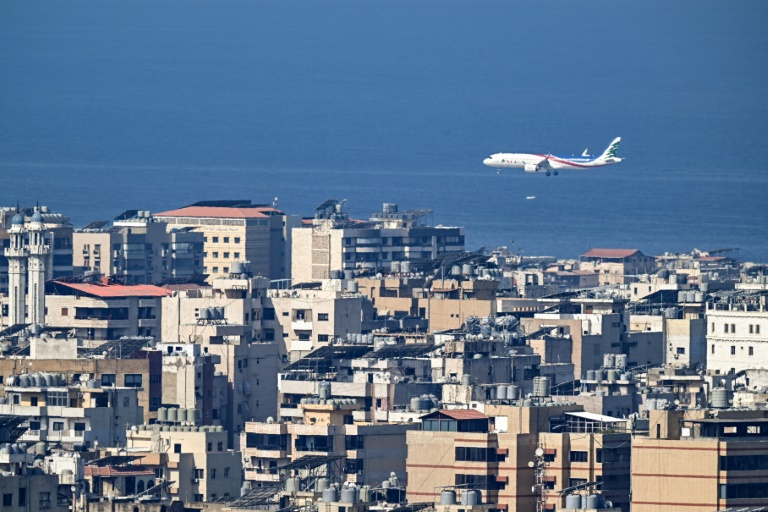 A commercial airplane flies over Beirut