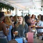 People attend 'The Girlies Club', a speed-dating-style networking event that brings together people looking for rental flatmates in London