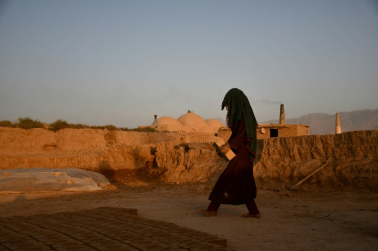 An Afghan woman works at a brick kiln on the outskirts of Mazar-I-Sharif