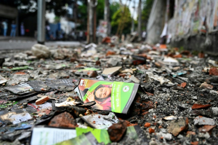 A burnt Awami League party office is pictured in Dhaka:  police reporting mobs had launched revenge attacks on Hasina's allies