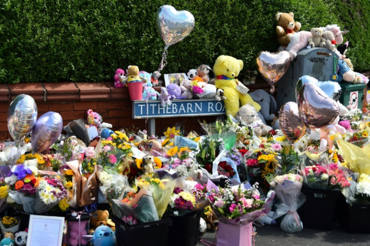 Floral tributes are left for the victims of a deadly knife attack in Southport, northwest England