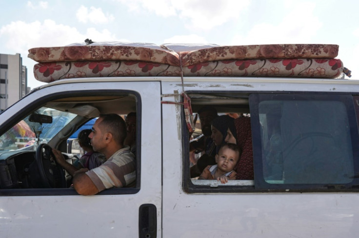 Gazans fleeing Al-Jalaa loaded mattresses, clothing and cooking utensils into pick-up trucks, while others left on foot