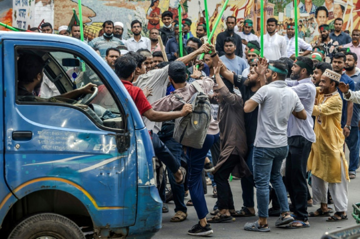 Mobs vowing to guard Bangladesh's student-led revolution roamed the site of a planned rally for ousted premier Sheikh Hasina on Thursday, beating up some of her suspected supporters with rods and pipes