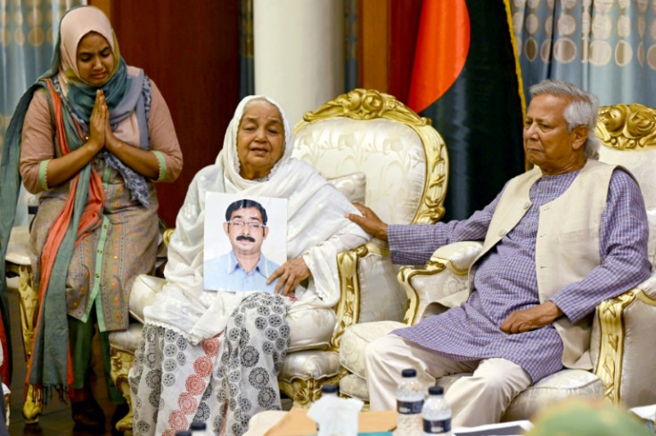 Muhammad Yunus, consoles Mayer Daak founder Hazera Khatun as she holds a portrait of her son Sajedul Islam Sumon, who went missing during Hasina's tenure