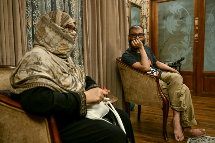 Quasem looks on as his mother Khondoker Ayesha Khatoon speaks during an interview with AFP following his eight-year imprisonment