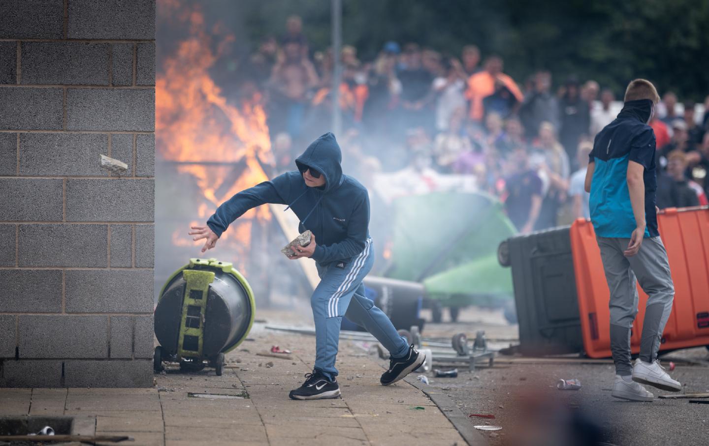 Anti-migration protesters throw chunks of concrete outside the Holiday Inn Express Hotel, which is housing asylum seekers on August 4, 2024, in Rotherham, United Kingdom.