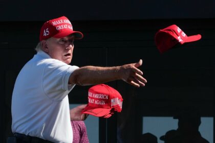 Donald Trump throwing hats at crowd