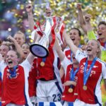 Arsenal players in red and white celebrating Champions League final victory in Lisbon