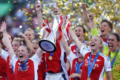 Arsenal players in red and white celebrating Champions League final victory in Lisbon
