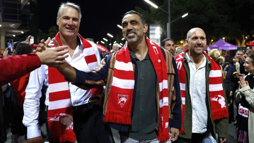 Adam Goodes at SCG with 2005 Sydney Swans premiership teammates holding the cup and greeting fans.