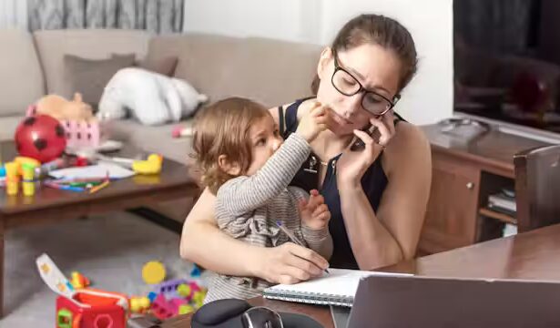 Parent sitting with autistic child, both appearing emotionally overwhelmed, showing the weight of caregiving.