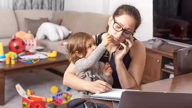 Parent sitting with autistic child, both appearing emotionally overwhelmed, showing the weight of caregiving.