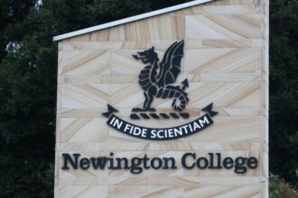 Newington College campus with coeducation announcement banner