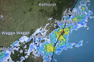 Digital weather forecast screen showing multi-day outlook with temperature highs and lows, rainfall predictions, and animated icons for sun, clouds, and storms across Sydney and surrounding regions.