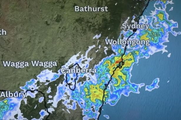 Digital weather forecast screen showing multi-day outlook with temperature highs and lows, rainfall predictions, and animated icons for sun, clouds, and storms across Sydney and surrounding regions.
