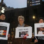 Activists holding Free Alaa signs outside British Consulate