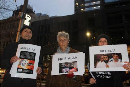 Activists holding Free Alaa signs outside British Consulate