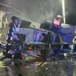 Overturned crane on Sydney M5 Motorway with emergency crews at the scene